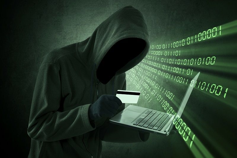 Internet theft concept - Man holding credit card with laptop on his hand